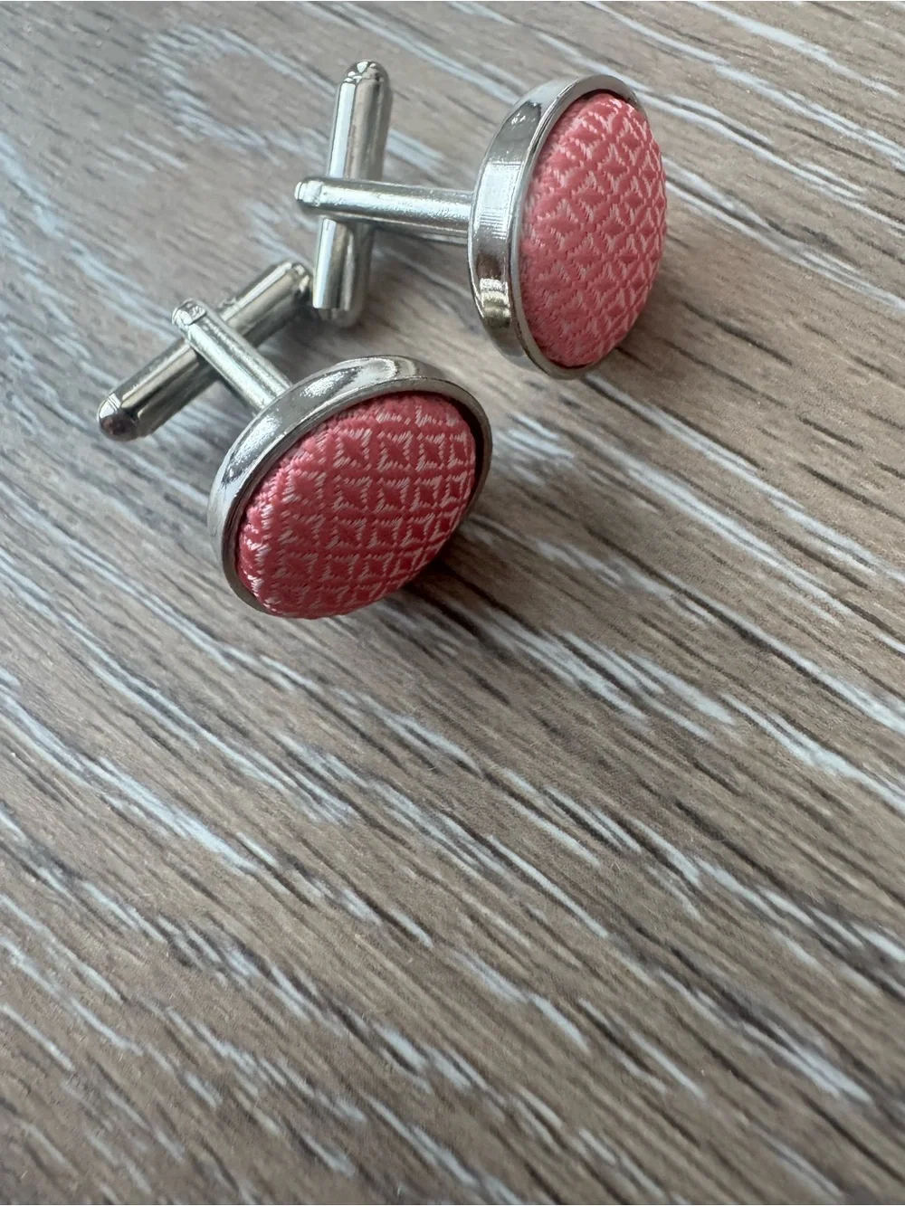 Pink textured cuff links in silver tone metal